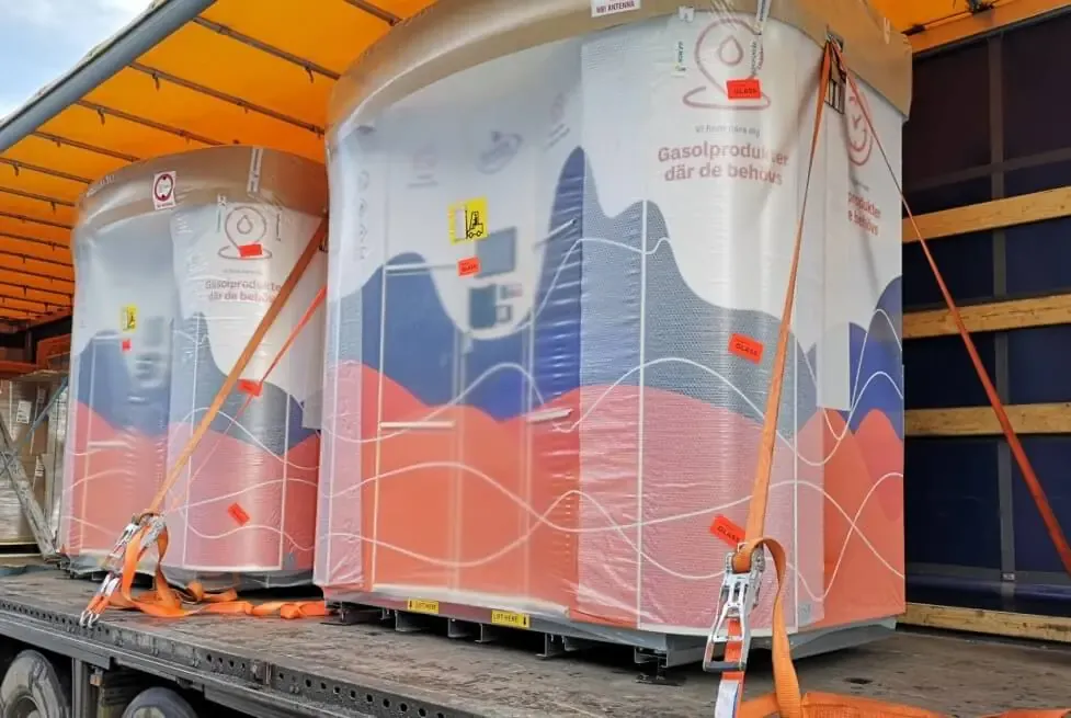 Two shrink-wrapped Vendanor vending machines strapped onto a truck bed for transport and delivery.